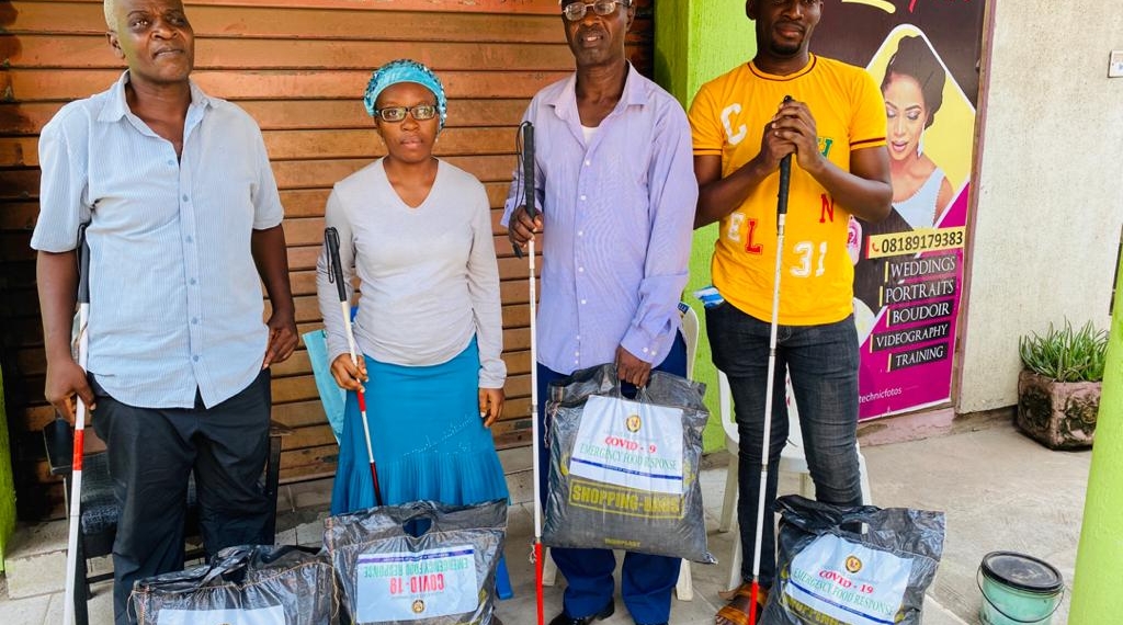 Three Male and one female blind with the COVID 19 food pack