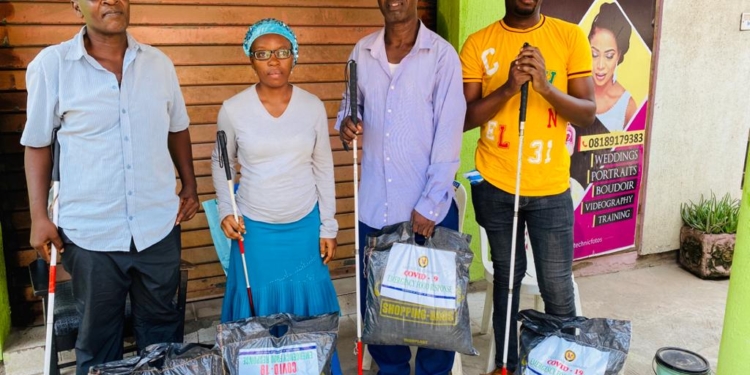 Three Male and one female blind with the COVID 19 food pack