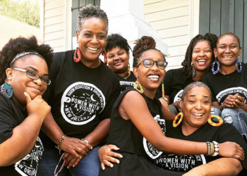 Seven women seating together in a group photograph
