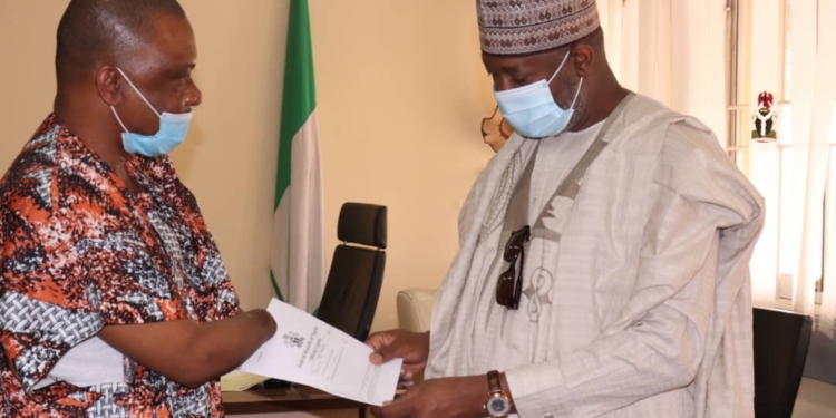 A male amputee presenting a letter to a man, both men facing each other
