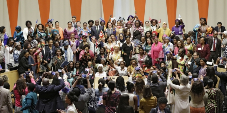 Many women taking group photograph
