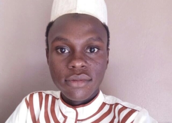 Man standing, wearing a cap