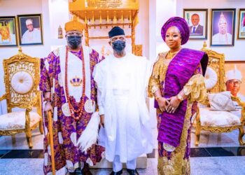 2 men and one woman standing together in a picture