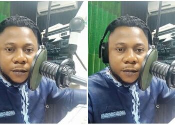 A man sitting and speaking to a microphone