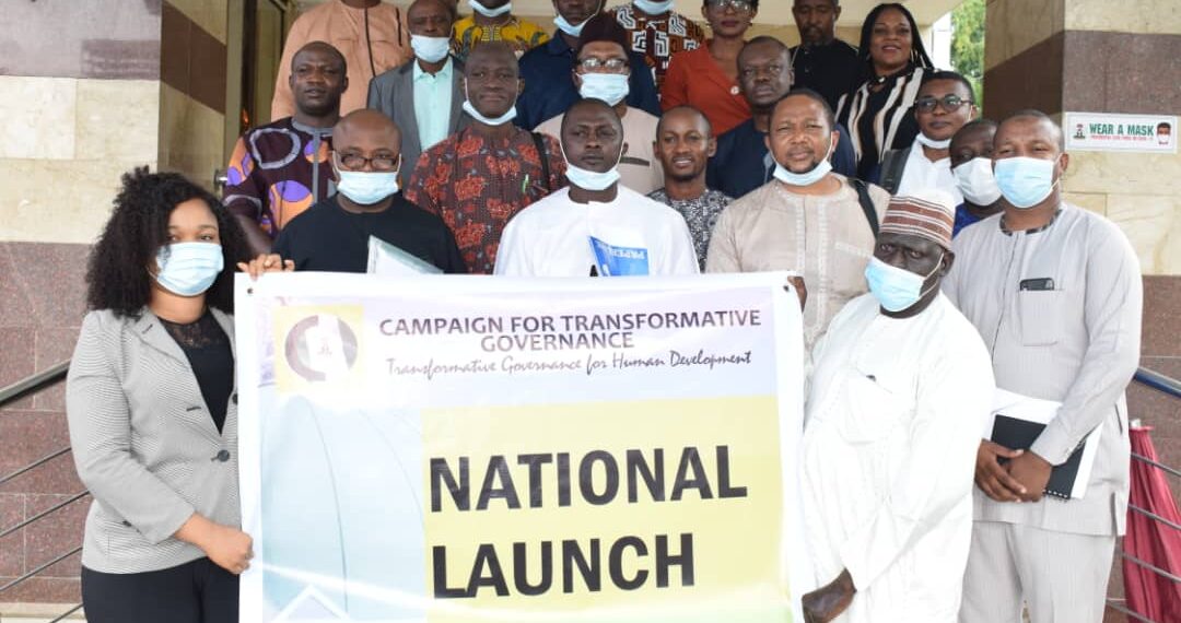 People in a group picture holding a banner