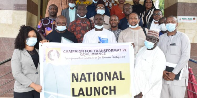 People in a group picture holding a banner
