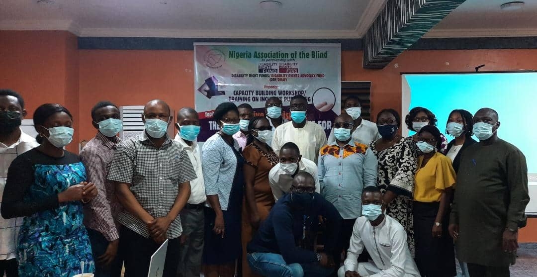 Group Picture, banner at the background and everyone in the picture is wearing facemask.