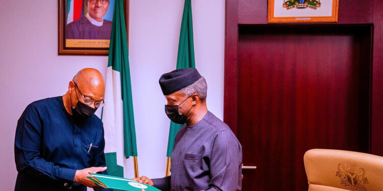 Two men standing together and posing a photo with a package in their hand