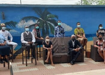 Group picture of people seated, maintaining social distancing