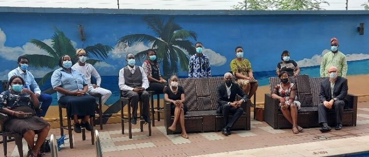 Group picture of people seated, maintaining social distancing