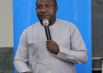 A man standing and holding a microphone