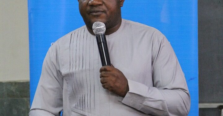 A man standing and holding a microphone