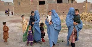 Women carrying children in their hands, showing that they are in distress, some children are also walking behind them.