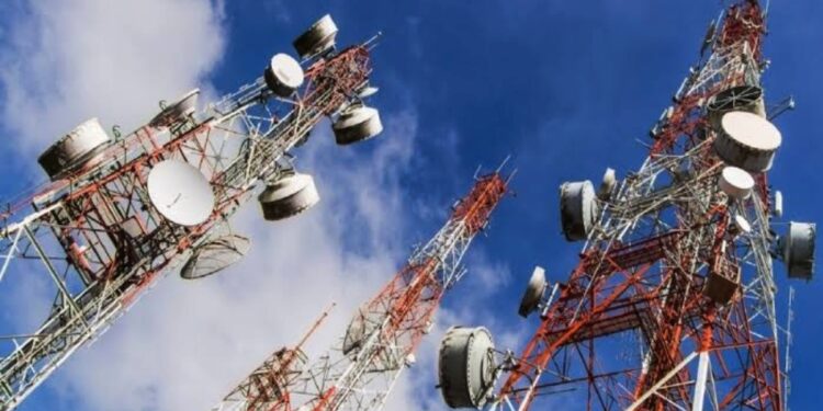 Tall telecoms masts view fromm bottom showing a blue sky above