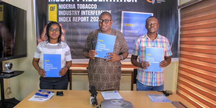 Three people in a picture holding the publication