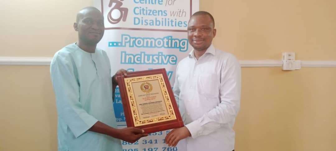 Mr. Ebenezer Ogunleye presenting patriotic leadership award to Mr. David Anyaele of CCD