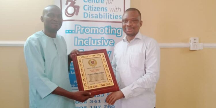 Mr. Ebenezer Ogunleye presenting patriotic leadership award to Mr. David Anyaele of CCD