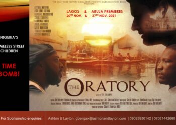 The Oratory movie flier. On it is an image of the face of one man on the left facing the image of another man on the right. Directly above the man on the right is the face of another man. Three faces in total on the image. Also written in it is the Oratory