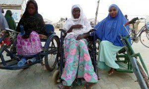 Three women on wheel chairs outdoor. They have hijabs on