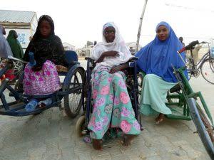 Three women on wheel chairs outdoor. They have hijabs on