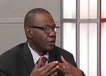 Image of ABCON President Aminu Gwadabe, making gestures with his hand indoor. He is putting on glasses