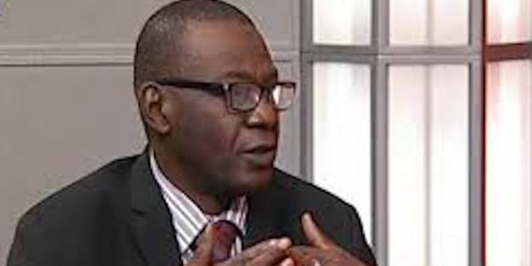 Image of ABCON President Aminu Gwadabe, making gestures with his hand indoor. He is putting on glasses