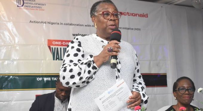 A woman standing and holding a microphone