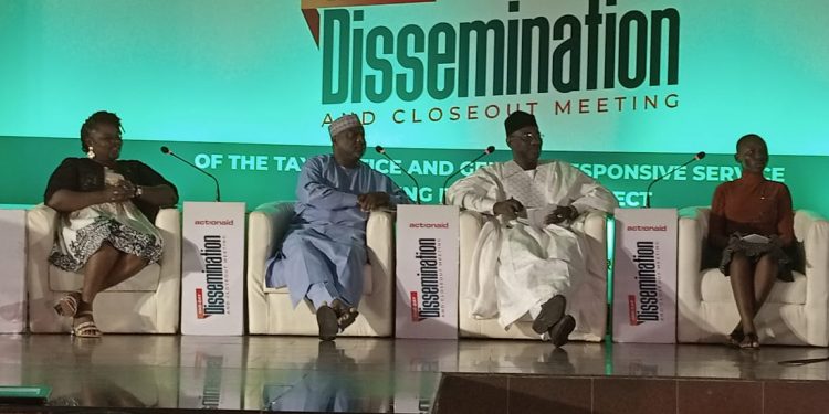 Two women and two men sitting on an elevated platform indoor