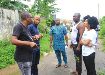Five people standing outside discusing