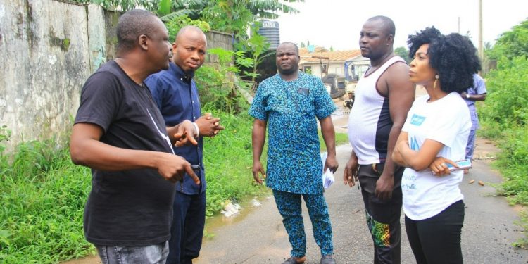 Five people standing outside discusing