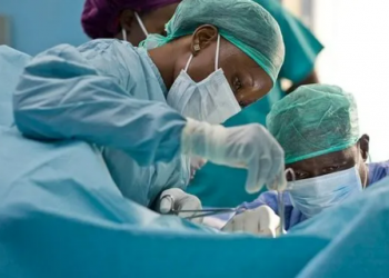close up view of two surgeons during an operation in a theatre
