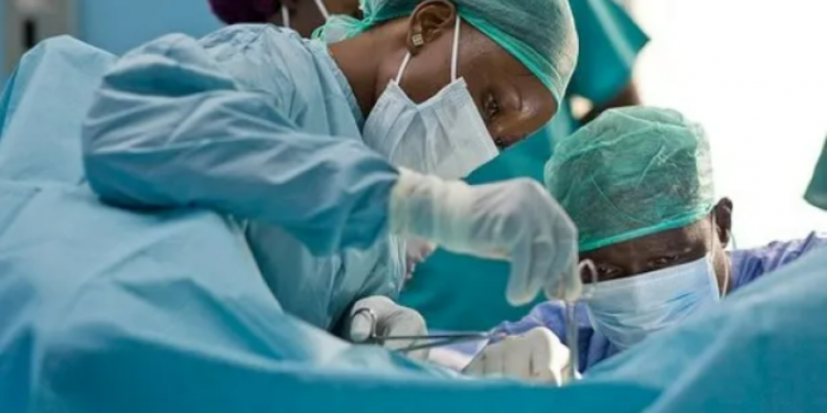 close up view of two surgeons during an operation in a theatre