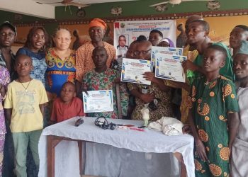 People in a group picture with some people holding their certificates