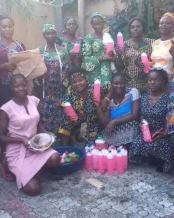 Women in a group picture after being taught economic skills such as soap making and pastry making.