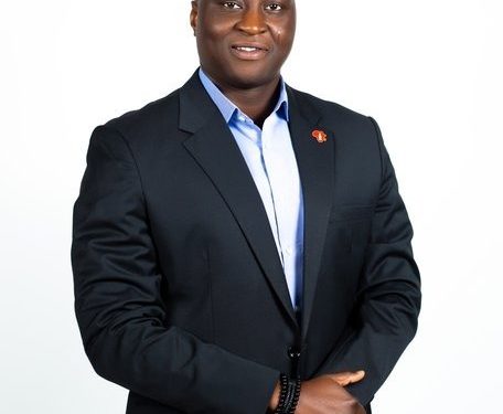 Image of a man standing indoor with wearing a suit