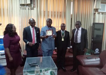 Four men and a woman standing indoor