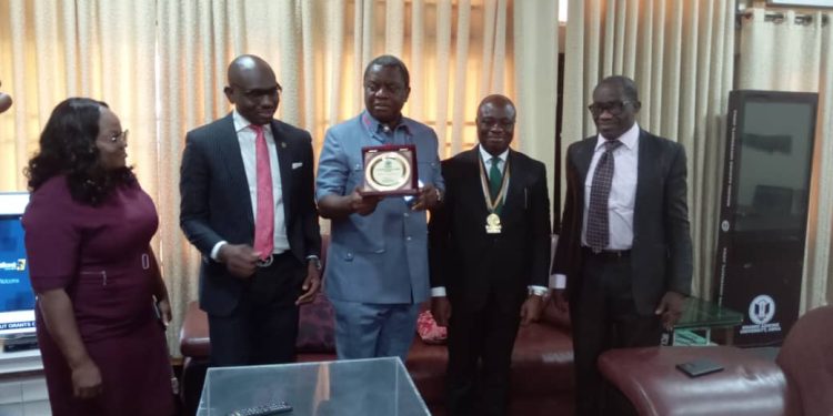 Four men and a woman standing indoor