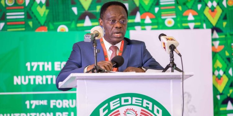 A man standing on a podium indoor