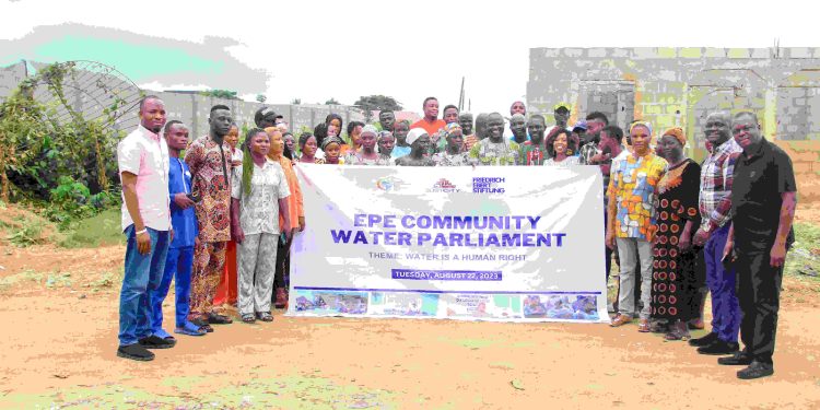 A group of people standing outdoor with a banner