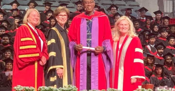 Four people standing together