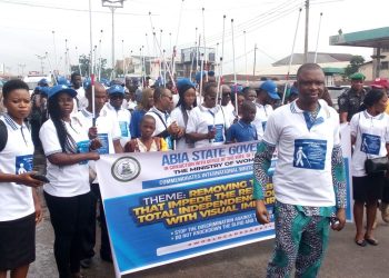 People outdoor holding up white canes in their hand