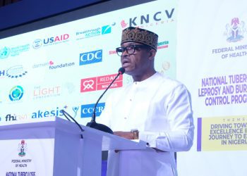 A man on white standing by the podium.