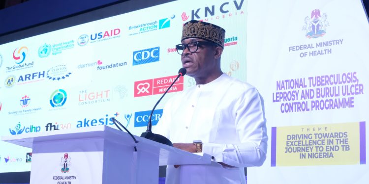 A man on white standing by the podium.