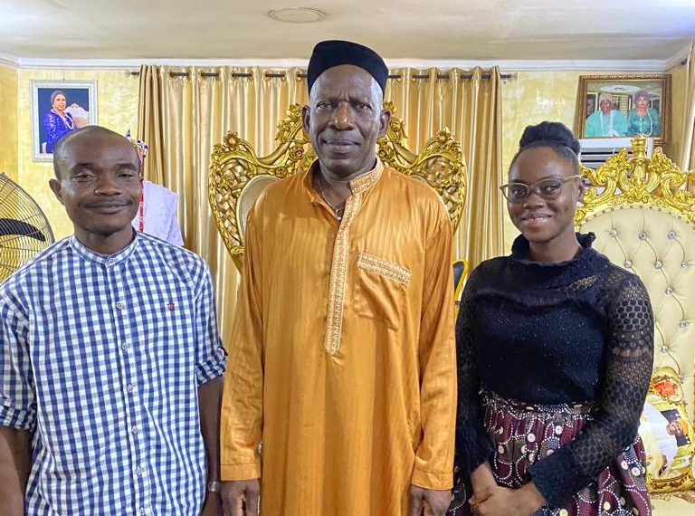 Three people in a group picture. two men and one woman.