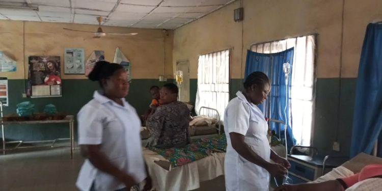 two women standing next to a hospital bed indoor