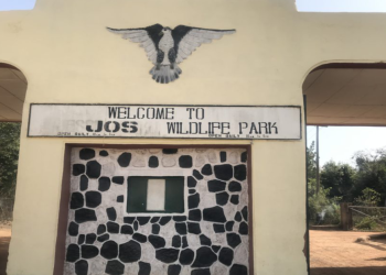 A tall gate with one entrance point on the right and exit on the left