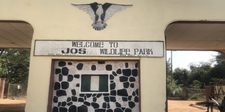 A tall gate with one entrance point on the right and exit on the left