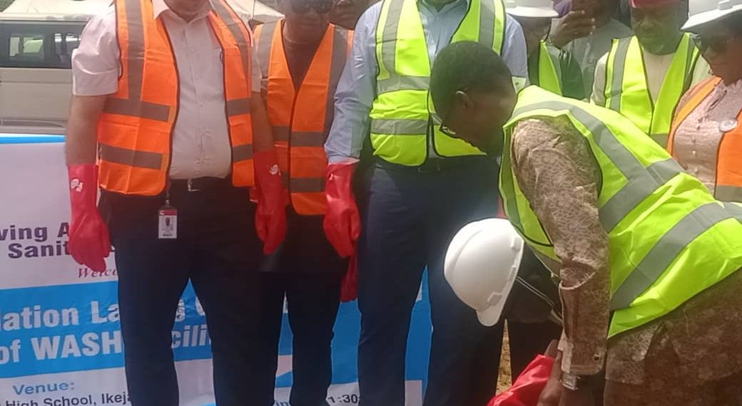 Image of people standing outdoor with helmets on their head and safety gloves on their hands