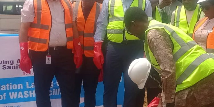 Image of people standing outdoor with helmets on their head and safety gloves on their hands