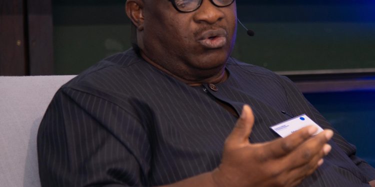 A man sitting on a chair indoor.